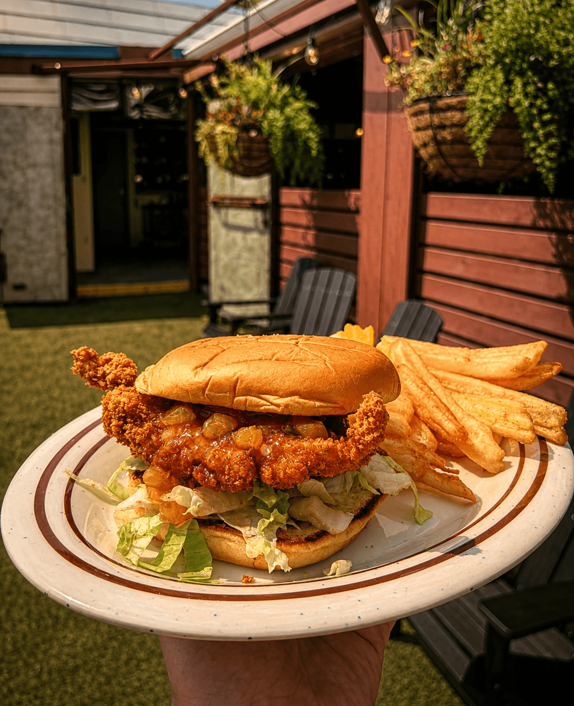 Crispy chicken sandwich and fries on the patio